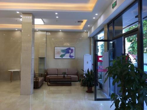 广州PAI Hotel Guangzhou Baiyun International Airport Zhongluotan Zhuliao Metro Station的大楼内带沙发的大堂