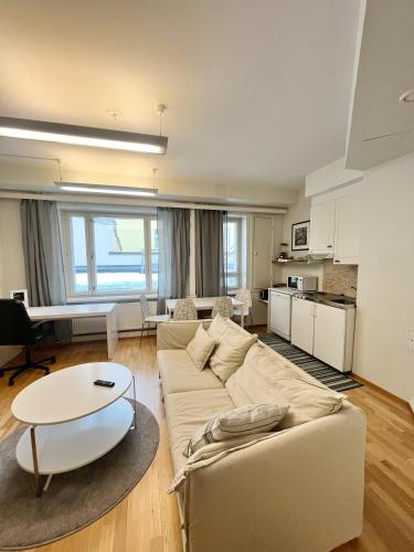 赫尔辛基Kotimaailma Apartments Kamppi - 1BR for 3 persons的客厅配有沙发和桌子