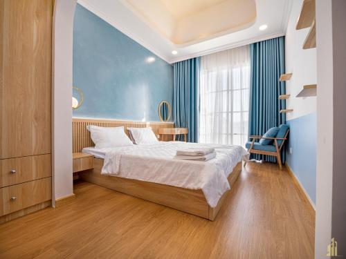 Bình TúDuy Quân Villa Novaworld Phan Thiết 10的一间卧室设有一张床和蓝色的墙壁