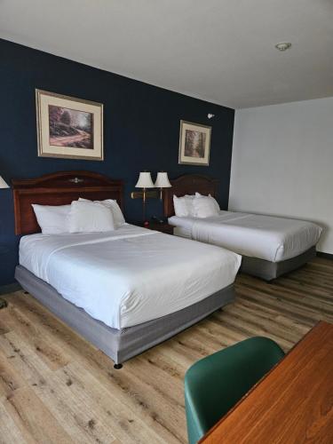 扬斯敦Wingate by Wyndham Youngstown - Austintown的酒店客房设有两张床和一张桌子。