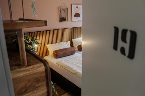 韦策雅各霍夫维策机场酒店的一间小卧室,配有白色床单