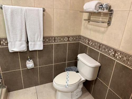 恩塞纳达港Baja Inn Hoteles Ensenada的浴室配有白色卫生间和毛巾。