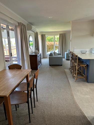 陶波Hilltop Cottage的客厅配有桌椅和沙发