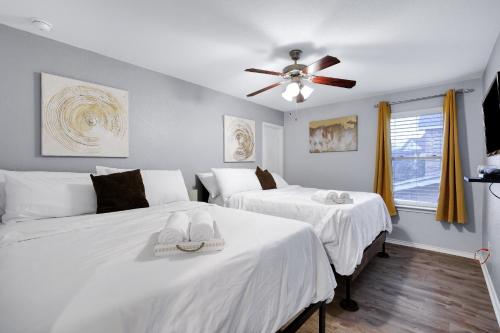 圣安东尼奥Tranquility - A Birdy Vacation Rental的一间卧室配有两张床和吊扇