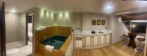 昆卡Hotel Ensueños的带浴缸和盥洗盆的浴室