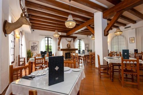 阿尔加尔Hotel Tugasa Villa de Algar的大型用餐室配有桌椅