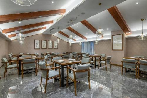 重庆Xiangsu Boang Hotel的用餐室配有木桌和椅子