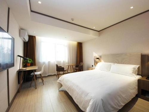 Hanting Hotel Hefei Baoye Dongcheng Plaza客房内的一张或多张床位