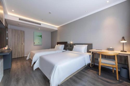 Hanting Premium Hotel Quzhuo Nanhu Plaza客房内的一张或多张床位