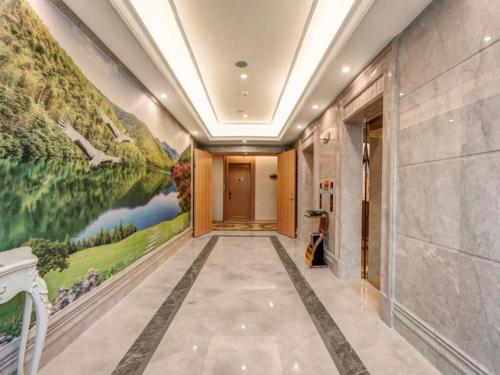 惠东Vienna Hotel Guangdong Huidong Exhibition Center的墙上挂有画的走廊