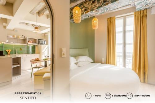 巴黎Beauquartier - Sentier的一间带白色床的卧室和一间厨房