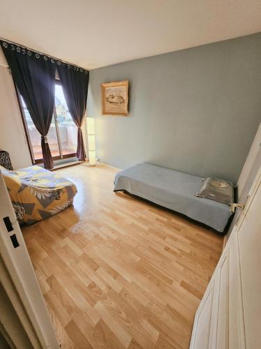 克雷泰伊Belle Chambre的一间卧室配有一张床,铺有木地板