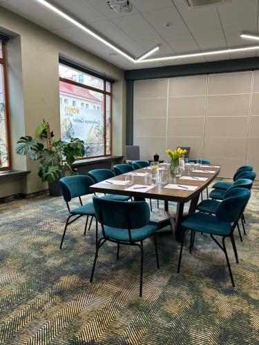 维尔纽斯CONTI HOTEL VILNIUS, Conference Centre, Restaurant & Bar的一间会议室,配有大桌子和椅子