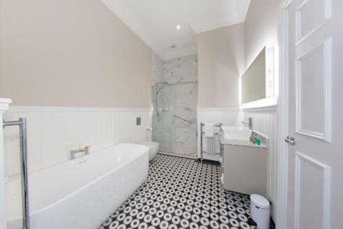 科芙考莫道儿酒店的白色的浴室设有浴缸和水槽。