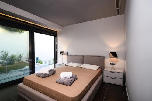 苏尼翁Luxury Beachfront Villa Selenia Gold in Sounio的一间卧室设有两张床和大窗户