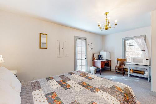 库珀维尔Cottage 9 - The Eagle's Nest的一间卧室配有一张床、一张书桌和一个窗户。