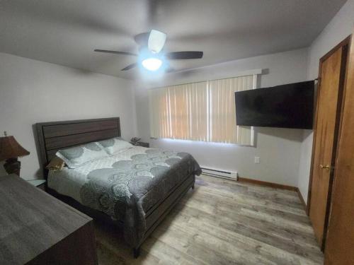 布什基尔Poconos Retreat的一间卧室配有一张床和吊扇