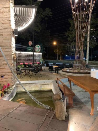 Ban Wa KachieoMe Design khao yai的庭院设有长凳、桌子和桌子。