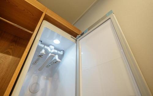 庆州H Avenue Gyeongju的浴室里设有玻璃门淋浴