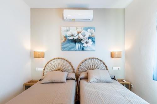 苏昂博Villa Terra的卧室内的两张床,墙上有绘画作品