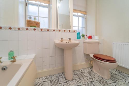 爱丁堡Large City Corner Apartment的浴室配有卫生间、盥洗盆和浴缸。