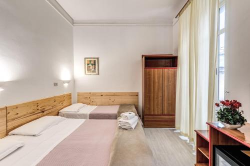 罗马阿尔塔维拉9号酒店的酒店客房设有两张床和窗户。