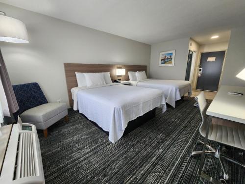 弗利Americas Best Value Inn & Suites-Foley的酒店客房,配有两张床和椅子