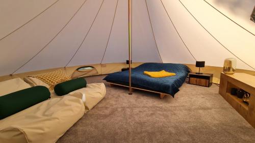 ChocianówGlampine的一个带一张沙发和一张桌子的帐篷的房间