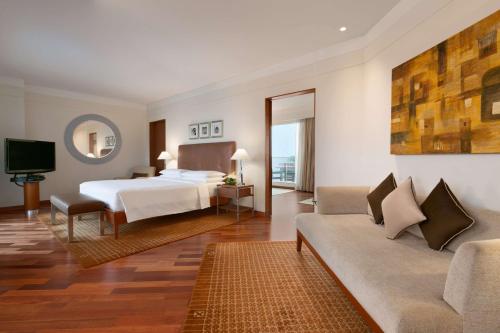 加尔各答加尔各答凯悦酒店的酒店客房,配有床和沙发