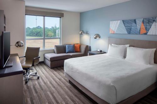 查尔斯顿Hyatt House Charleston/Mount Pleasant的配有一张床和一把椅子的酒店客房