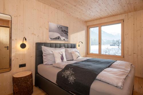 GalgenulHaus Valtellina的木制客房内的一间卧室,配有一张床