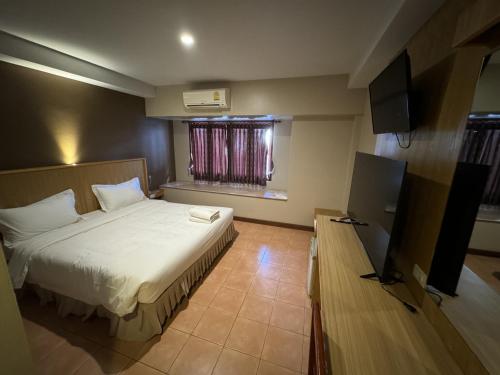 查汶P Chaweng的酒店客房,配有床和电视