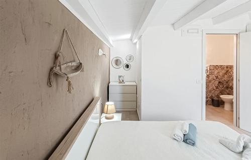 罗索利尼Nice Home In Rosolini With Wifi的白色的客房设有床和浴室。