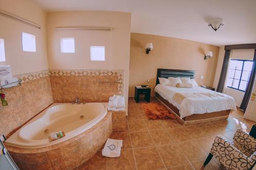 特基斯基亚潘圣何塞雷亚尔酒店的卧室配有床和浴缸