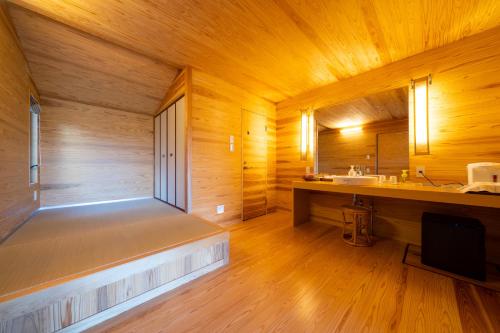 九重町斯帕格林尼斯旅馆的大型木制客房设有浴缸和水槽