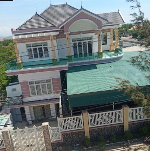 Thôn Hiếu ThiệnNhà Nghỉ Đăng Miên的一座带绿色屋顶和围栏的大房子