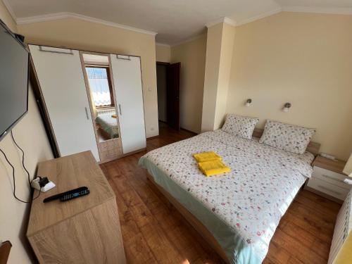 班斯科VV Apartment Bansko的一间卧室配有一张黄色毛巾的床
