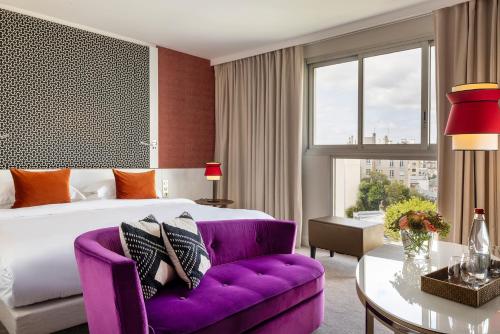 巴黎Hotel Villa Maillot的酒店客房设有一张床和一张紫色沙发