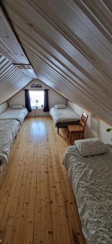 基律纳Arctic Cottage Kiruna, Groups的客房设有四张床,铺有木地板。