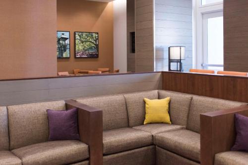查尔斯顿查尔斯顿凯悦酒店 - 位于历史区的一间设有一张长沙发的等候室,配有紫色和黄色枕头