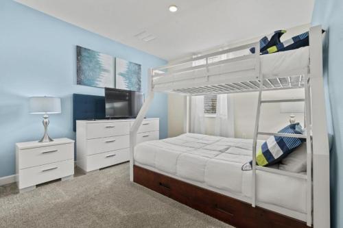 基西米Lovely Condos 18 Minutes away from Disney!的一间卧室配有双层床和电视。
