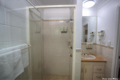 格拉德斯通The Queens Gladstone的一间带玻璃淋浴和水槽的浴室
