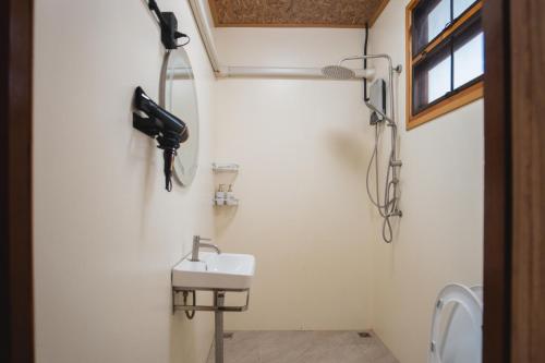 Tha KradanPhu Naphat Resort的一间带水槽的浴室和墙上的一部电话