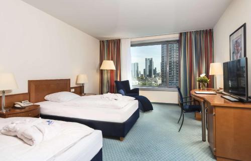 美因河畔法兰克福玛丽蒂姆法兰克福酒店的酒店客房设有两张床和电视。