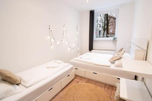 汉堡Great Three Bedroom Apartment的客房设有两张床和窗户。