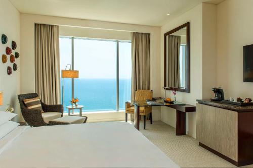 卡塔赫纳凯悦卡塔赫纳酒店的酒店客房设有一张床、一张书桌和一个大窗户。