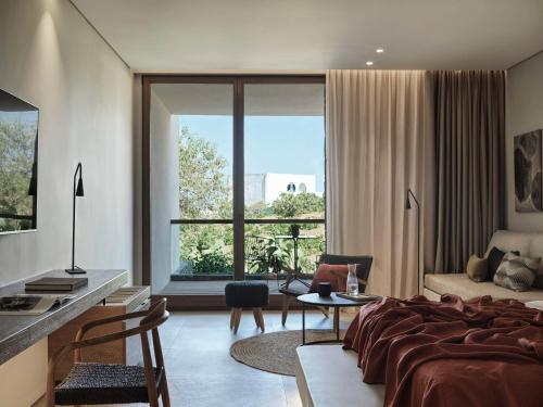 VourvoúlosMagma Resort Santorini, In The Unbound Collection By Hyatt的一间卧室设有一张床和一个大窗户