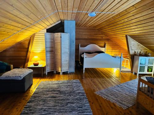 罗瓦涅米Lakeside Log Villa Edith的卧室配有木制天花板上的床铺