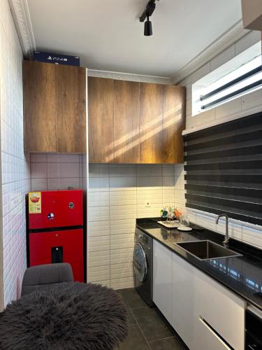 BaatsonaRich homes的厨房配有红色冰箱和水槽