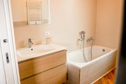 阿尔本加Villa Essenza - Rooms and Breakfast的浴室配有盥洗盆和浴缸。